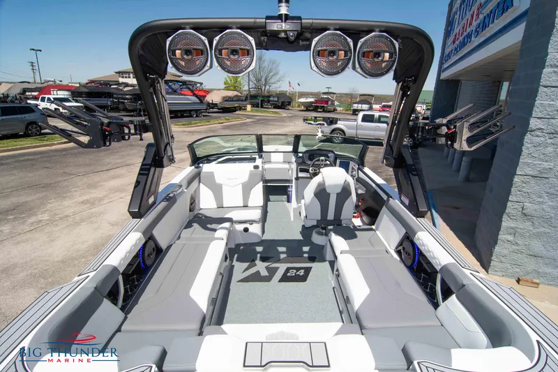 Slide: The Image of 2024 MasterCraft XT24 boat interior with sleek seating and advanced audio system. - 14