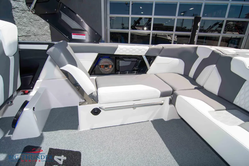 Slide: The Image of 2024 MasterCraft XT24 boat interior with gray and white seating and modern design. - 19