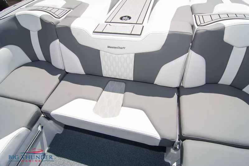 Slide: The Image of 2024 MasterCraft XT24 boat interior with gray and white cushioned seating. - 23