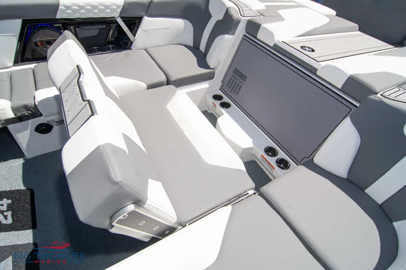 Slide: The Image of 2024 MasterCraft XT24 boat interior with gray and white seating, showcasing modern design and comfort. - 24