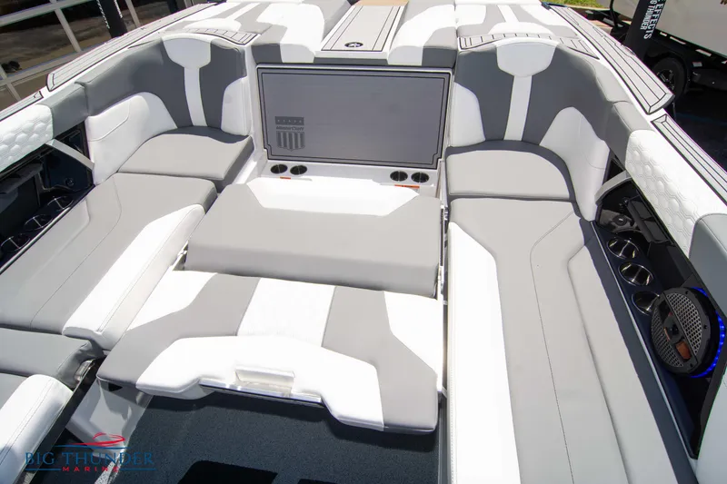 Slide: The Image of 2024 MasterCraft XT24 boat interior with sleek gray and white seating design. - 25