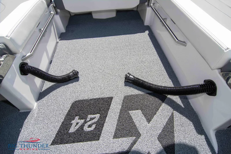 Slide: The Image of 2024 MasterCraft XT24 boat interior with logo on carpeted floor. - 33