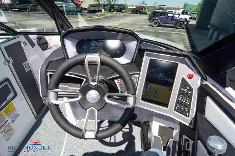 Slide: The Image of 2024 MasterCraft XT24 boat dashboard with steering wheel and digital display. - 36