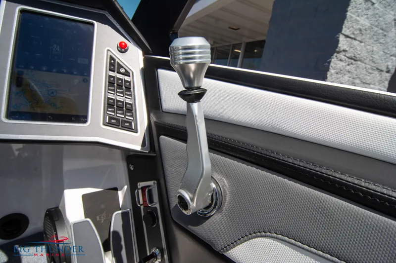 Slide: The Image of 2024 MasterCraft XT24 boat control panel with throttle lever and touchscreen display. - 40