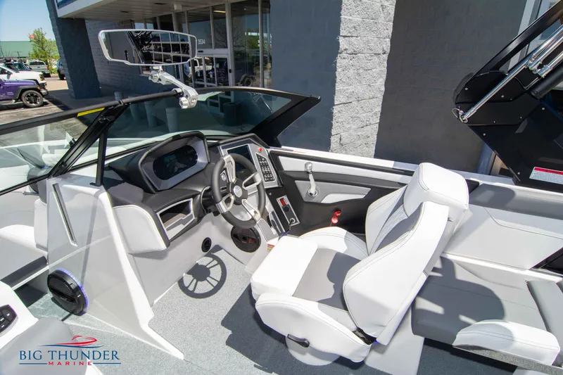 Slide: The Image of 2024 MasterCraft XT24 boat interior with modern dashboard and white seating at Big Thunder Marine. - 42