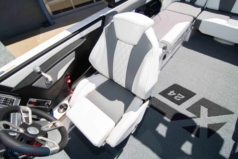 Slide: The Image of 2024 MasterCraft XT24 boat interior with captain's chair and steering wheel. - 43