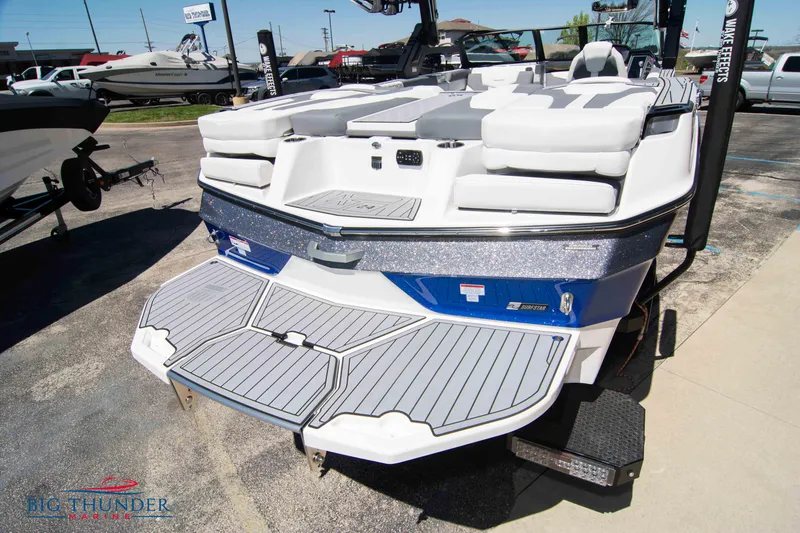 Slide: The Image of 2024 MasterCraft XT24 boat with spacious deck and sleek design. - 9