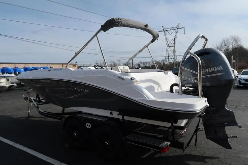 Slide: The Image of 2023 Hurricane SunDeck Sport 205 OB boat with Yamaha outboard motor on trailer. - 10