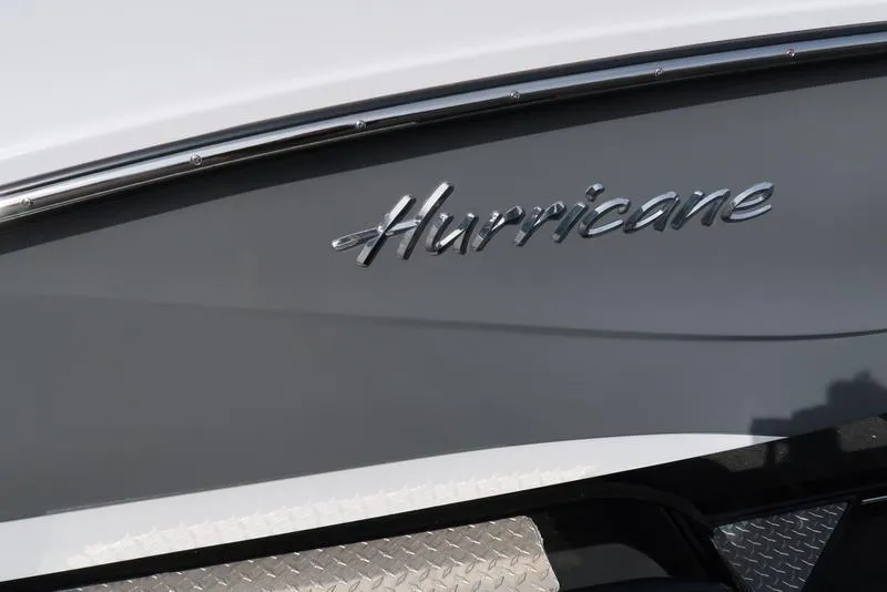 Slide: The Image of 2023 Hurricane SunDeck Sport 205 OB boat logo on sleek gray hull. - 12
