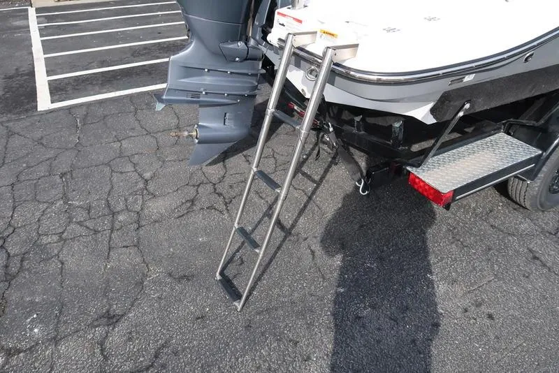 Slide: The Image of 2023 Hurricane SunDeck Sport 205 OB boat with ladder and outboard motor on asphalt. - 14