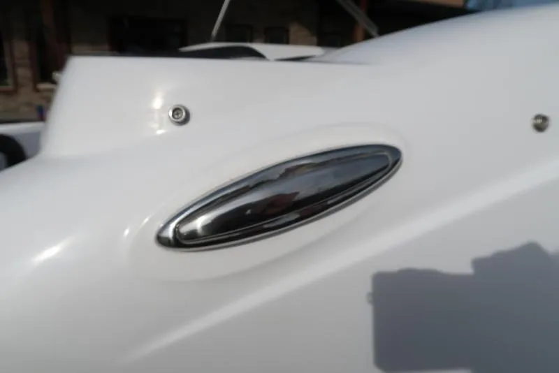 Slide: The Image of 2023 Hurricane SunDeck Sport 205 OB boat detail, featuring sleek chrome accent on white surface. - 17