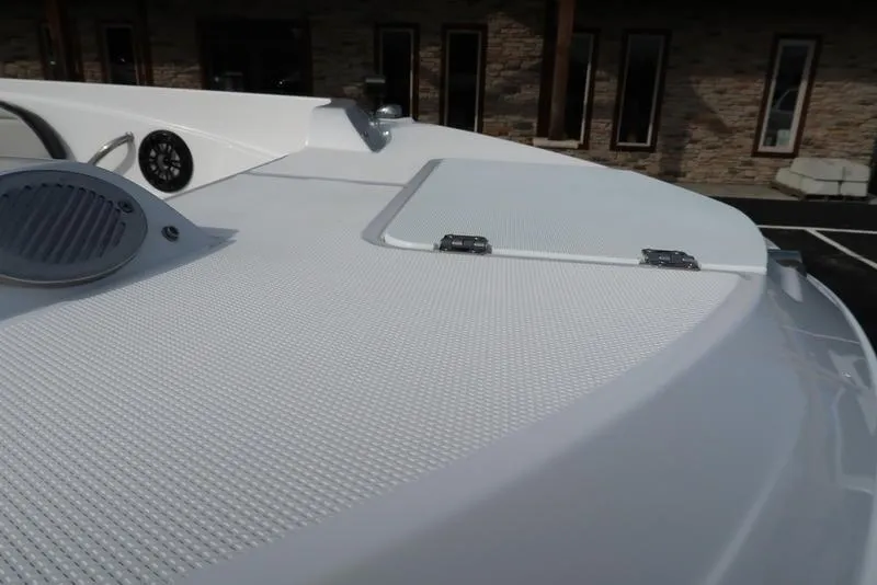 Slide: The Image of 2023 Hurricane SunDeck Sport 205 OB boat deck with textured surface and speaker. - 18