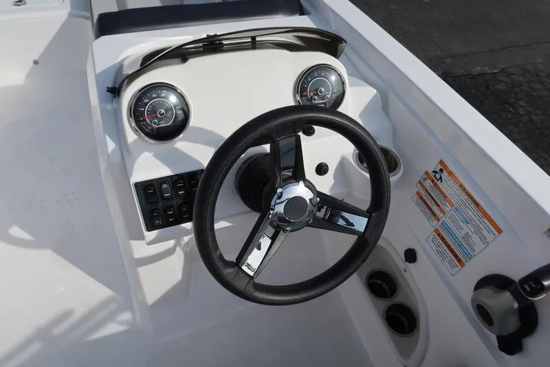 Slide: The Image of 2023 Hurricane SunDeck Sport 205 OB boat dashboard with steering wheel and gauges. - 36