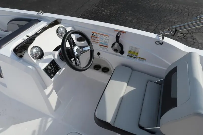 Slide: The Image of 2023 Hurricane SunDeck Sport 205 OB boat interior with steering wheel and seating. - 37