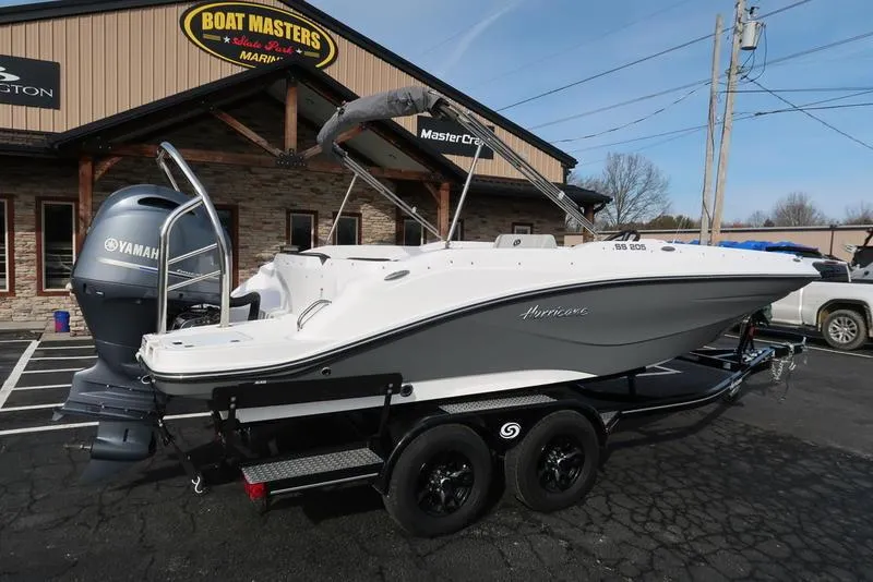 Slide: The Image of 2023 Hurricane SunDeck Sport 205 OB boat on trailer, parked outside dealership. - 4