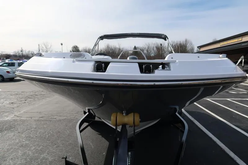 Slide: The Image of 2023 Hurricane SunDeck Sport 205 OB boat on trailer, front view in parking lot. - 7