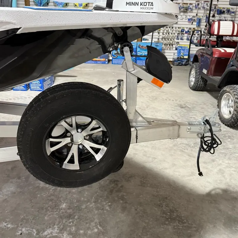 Slide: The Image of Trailer wheel of 2025 Express H20 Bay boat in a showroom. - 12