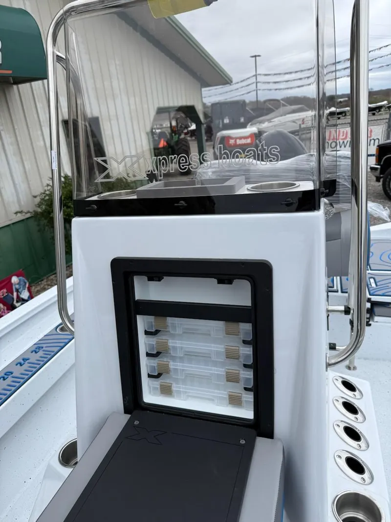 Slide: The Image of 2025 Express H20 Bay boat console with storage compartments and rod holders. - 3