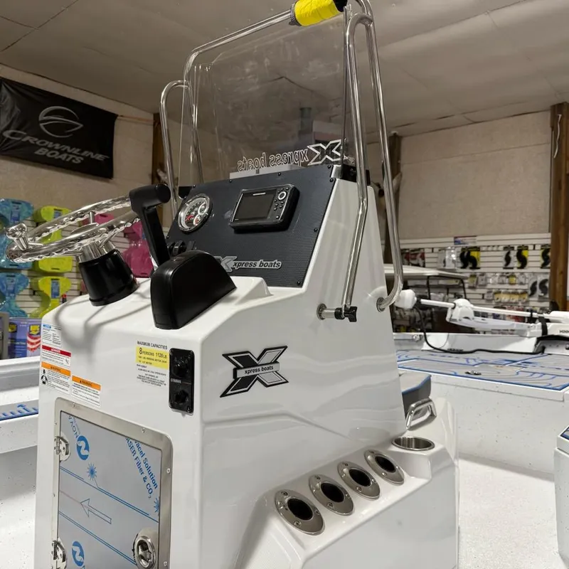 Slide: The Image of 2025 Express H20 Bay boat console with steering wheel and controls in showroom. - 4