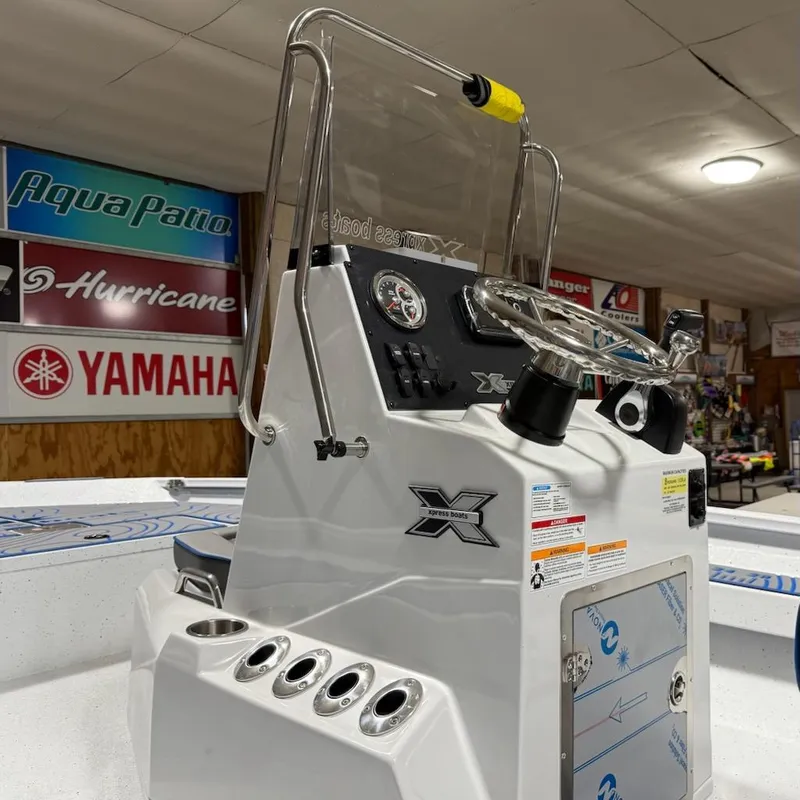 Slide: The Image of 2025 Express H20 Bay boat console with steering wheel and gauges in showroom. - 5