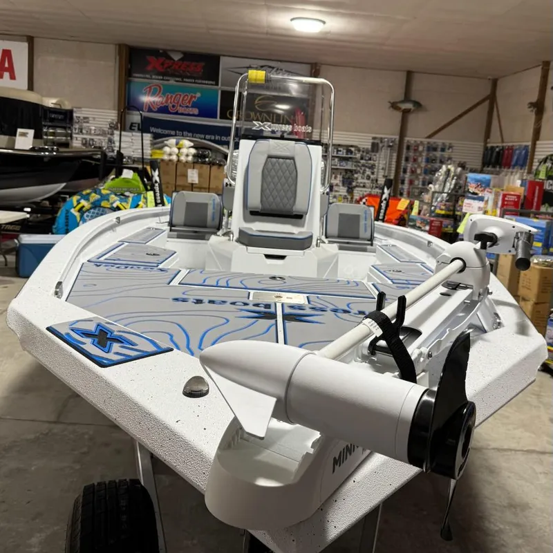 Slide: The Image of 2025 Express H20 Bay boat displayed in a showroom with fishing equipment. - 9