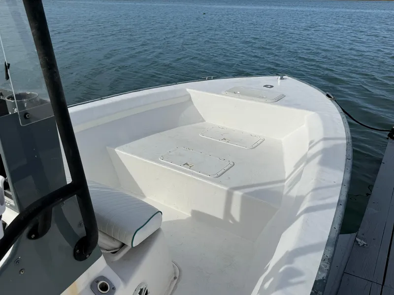 Slide: The Image of 2003 Key Largo 216cc boat docked on calm water. - 10