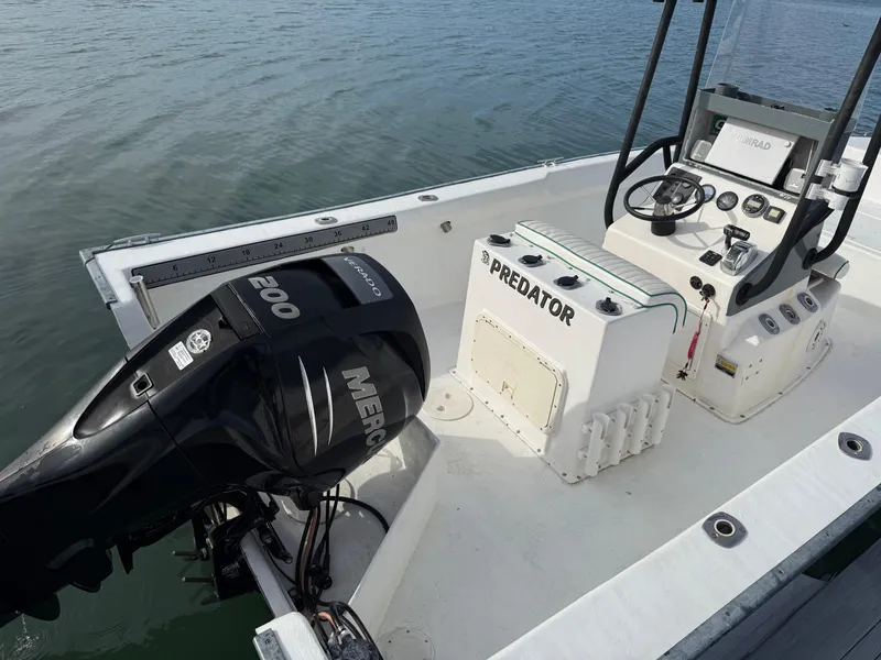 Slide: The Image of 2003 Key Largo 216cc boat with Mercury 200 engine on calm water. - 12