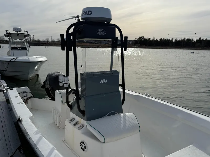 Slide: The Image of 2003 Key Largo 216cc boat docked on a calm waterway. - 14
