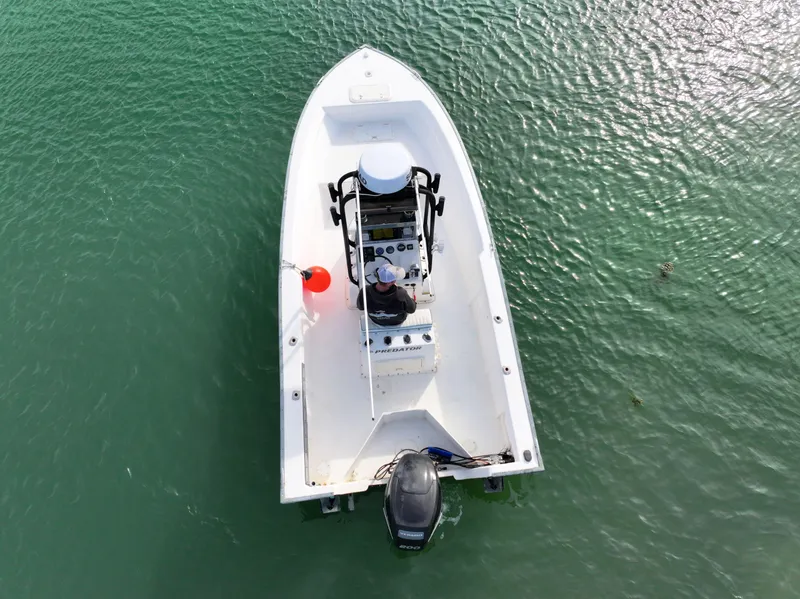 Slide: The Image of Aerial view of 2003 Key Largo 216cc boat on calm green water. - 4