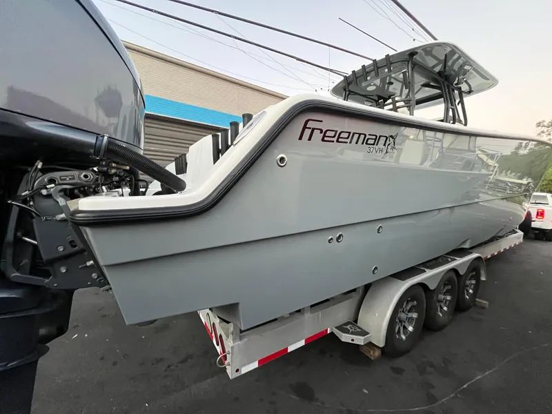 Slide: The Image of Freeman 37 VH 2017 boat on trailer, side view, gray color, outdoor setting. - 1