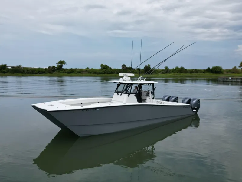 Slide: The Image of 2017 Freeman 37 VH boat on calm water with triple outboard engines. - 14