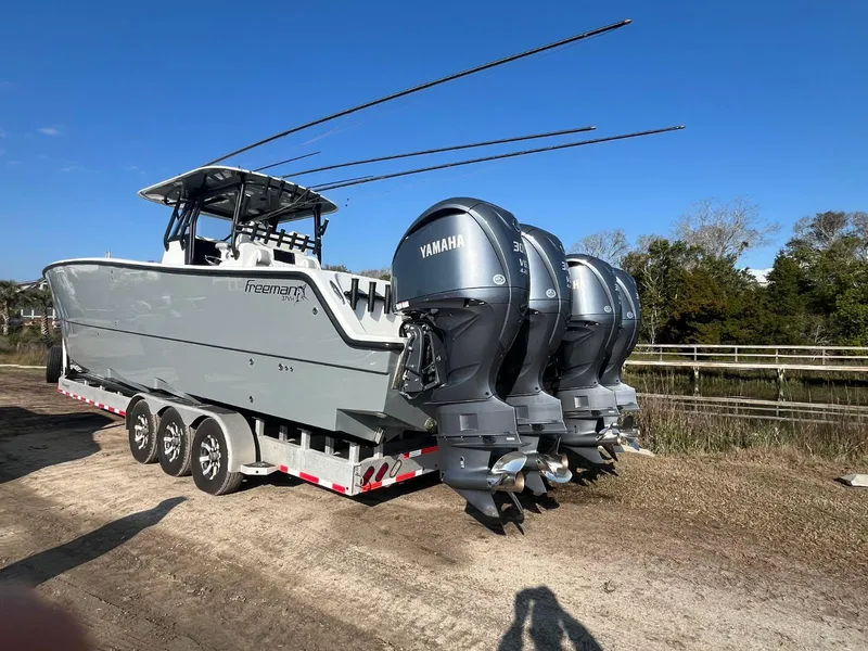 Slide: The Image of 2017 Freeman 37 VH boat with Yamaha engines on a trailer, parked outdoors. - 2