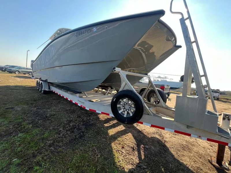 Slide: The Image of Freeman 37 VH 2017 boat on trailer, parked outdoors on grass. - 3