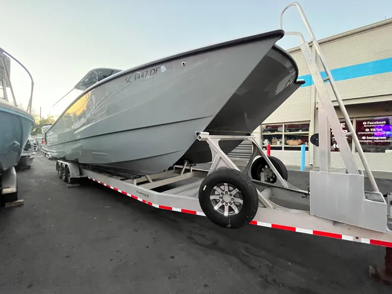 Slide: The Image of 2017 Freeman 37 VH boat on trailer, parked outside a building. - 8
