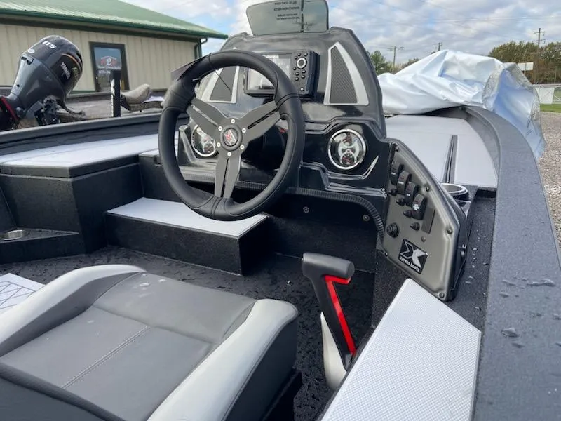 Slide: The Image of 2025 Xpress H20 Bass boat interior with steering wheel and control panel. - 11