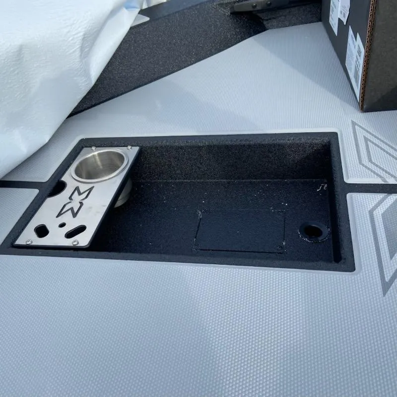 Slide: The Image of 2025 Xpress H20 Bass boat deck with storage compartment and cup holder. - 6