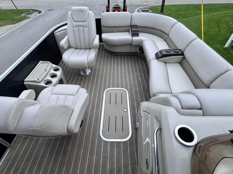 Slide: The Image of 2014 Bennington 2575 RCW pontoon boat interior with plush seating and cup holders. - 12
