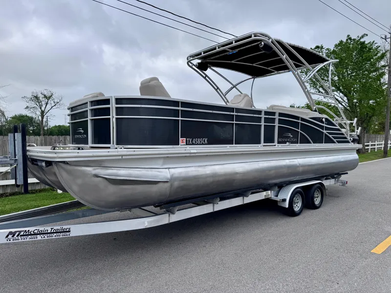 Slide: The Image of 2014 Bennington 2575 RCW pontoon boat on trailer, parked on roadside. - 2