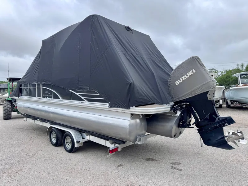 Slide: The Image of 2014 Bennington 2575 RCW pontoon boat on trailer, covered, with Suzuki outboard motor. - 21