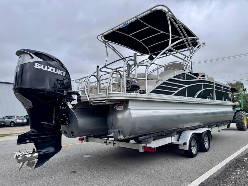 Slide: The Image of 2014 Bennington 2575 RCW pontoon boat on trailer with Suzuki outboard motor. - 5