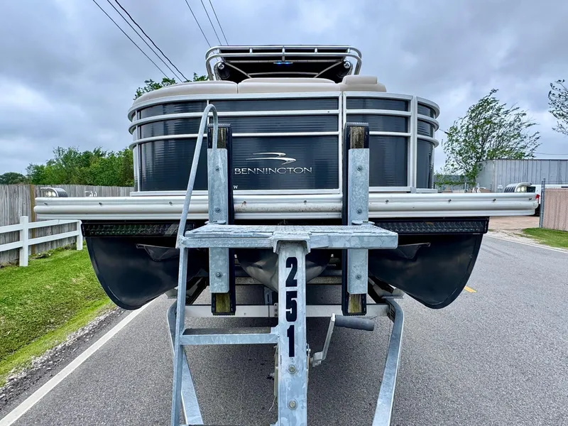 Slide: The Image of 2014 Bennington 2575 RCW pontoon boat on trailer, parked on a road. - 7
