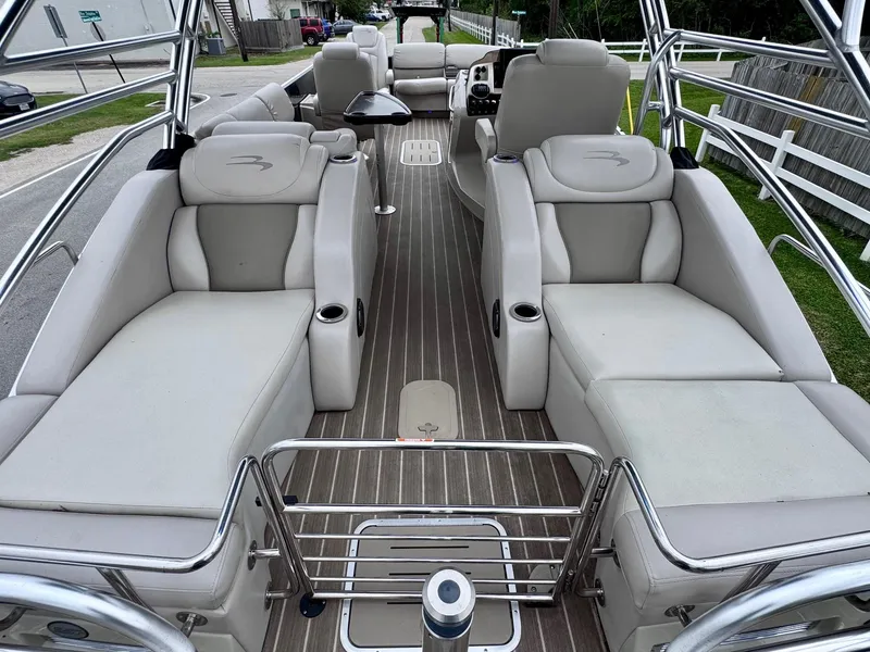 Slide: The Image of 2014 Bennington 2575 RCW pontoon boat with luxurious seating and sleek design. - 8