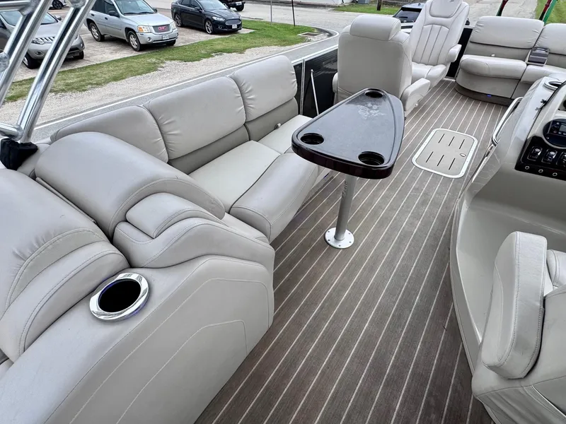 Slide: The Image of 2014 Bennington 2575 RCW boat interior with plush seating and sleek table. - 9