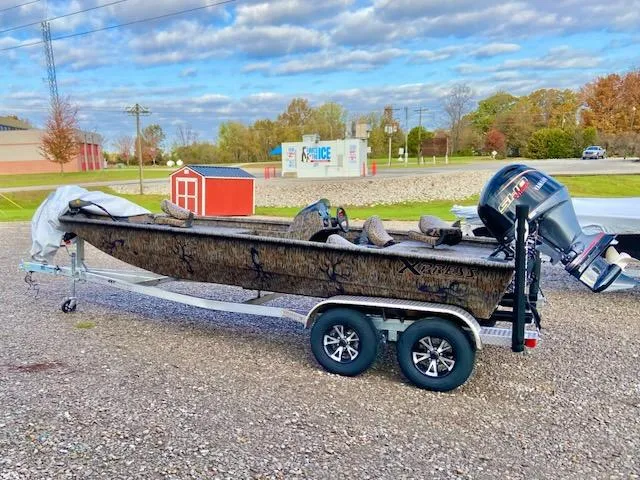 Slide: The Image of 2025 Xpress XP200 Catfish boat on trailer, parked outdoors under cloudy sky. - 1