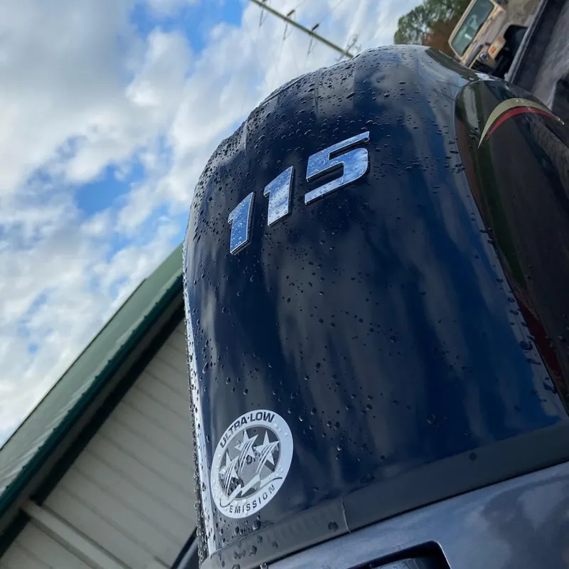 Slide: The Image of Close-up of 115 horsepower engine on 2025 Xpress XP200 Catfish boat, featuring ultra-low emission sticker. - 2