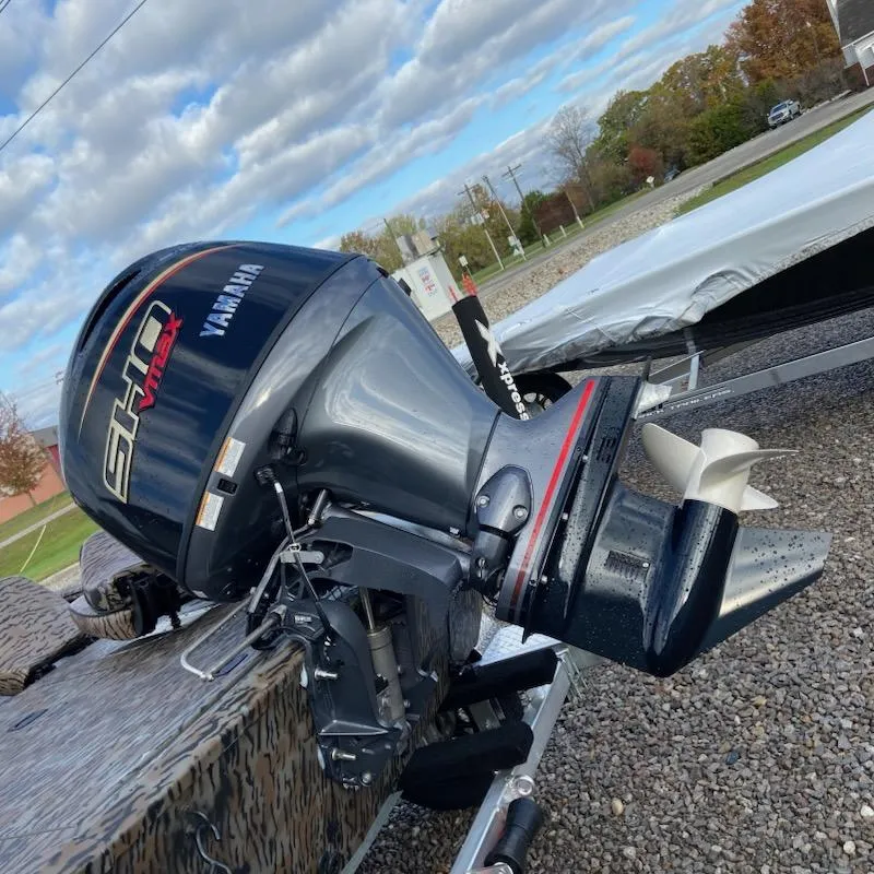 Slide: The Image of 2025 Xpress XP200 Catfish boat with Yamaha outboard motor, parked on gravel. - 3