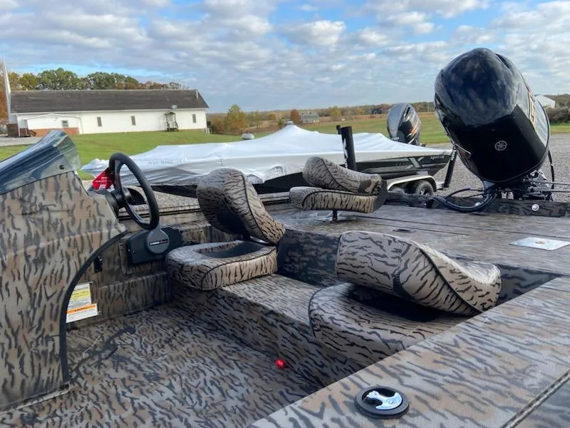 Slide: The Image of 2025 Xpress XP200 Catfish boat with camo interior and powerful outboard motor. - 4