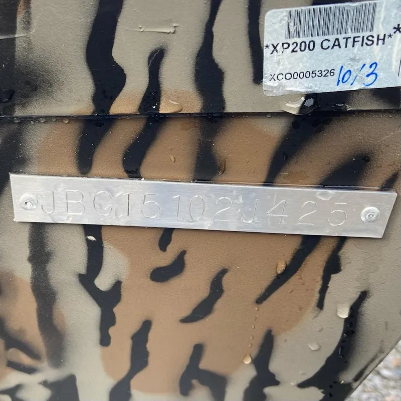 Slide: The Image of 2025 Xpress XP200 Catfish boat with camouflage pattern and identification plate. - 8