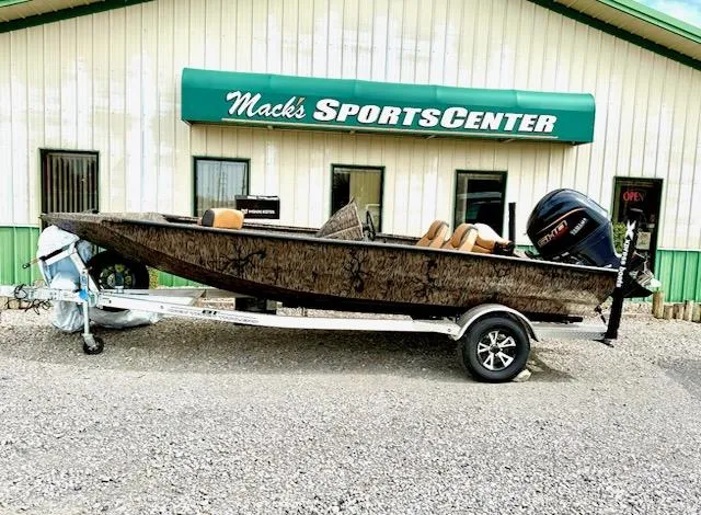The Image of 2025 Xpress H18 Bass boat on trailer outside Mack's Sports Center. - 1
