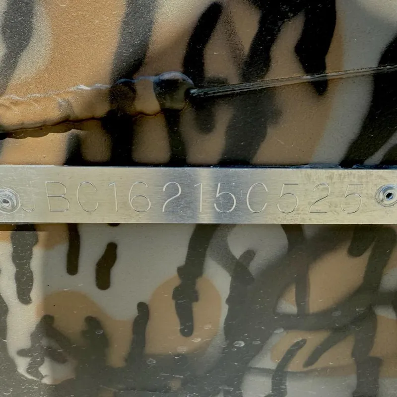 Slide: The Image of 2025 Xpress H18 Bass boat with camouflage pattern and visible serial number plate. - 11